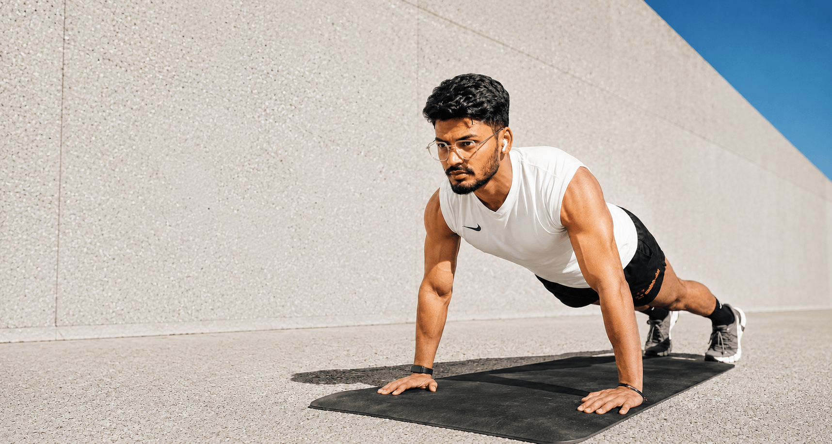 Male athlete performing pushups workout at TheFitHab